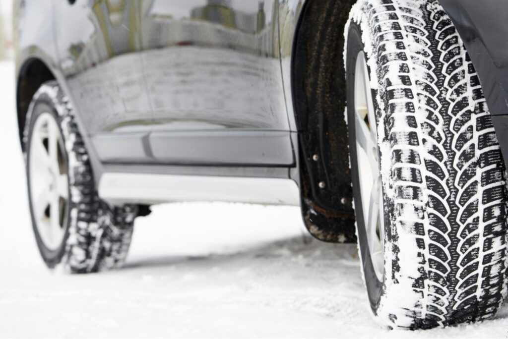 雪道を走るスタッドレスタイヤのアップ