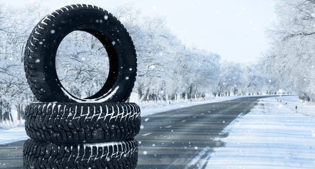 Winter tires on a snowy road. Seasonal tire change.