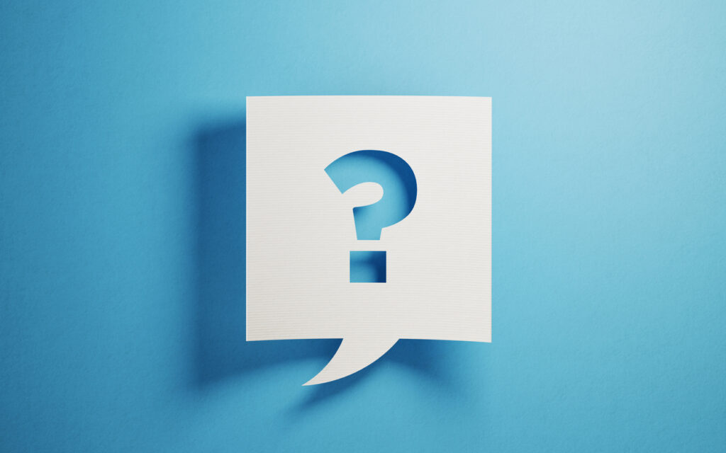 White chat bubble on blue background. There is a question mark symbol on chat bubble. Horizontal composition with copy space.