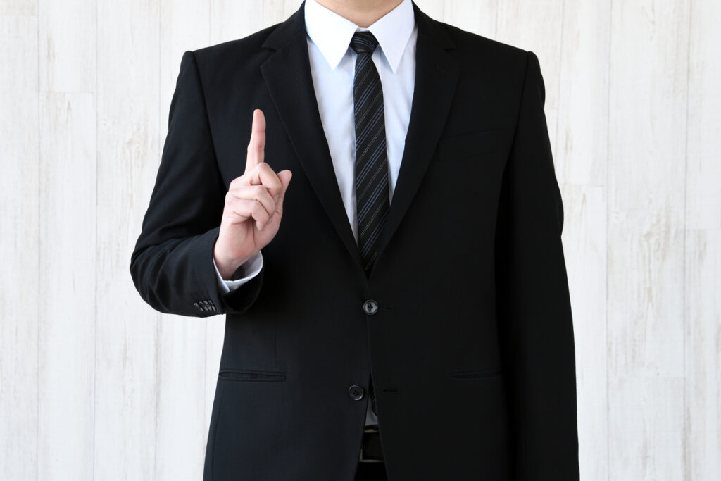 Business man putting up index finger
