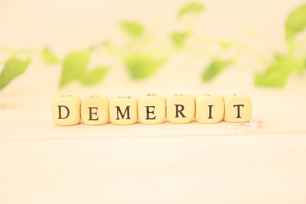 This is a cube of alphabet letters of "DEMERIT".