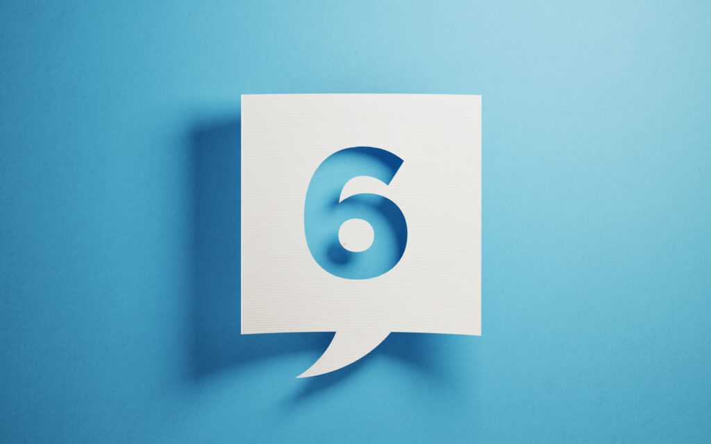 White chat bubble on  blue background. Number six writes on chat bubble. Horizontal composition with copy space.