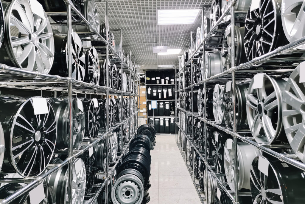 Auto shop selling car rims. Stand for sale of alloy wheels. Discounts at auto parts store. Various wheel models.