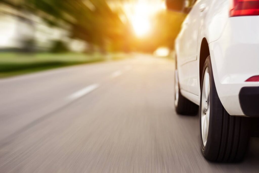 Car ride on road at sunset with copy space, motion blur