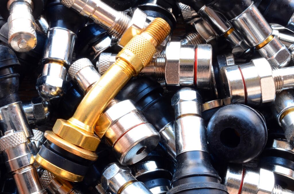 An abstract image of several loose tire valve stems.