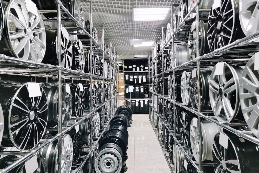 Auto shop selling car rims. Stand for sale of alloy wheels. Discounts at auto parts store. Various wheel models.