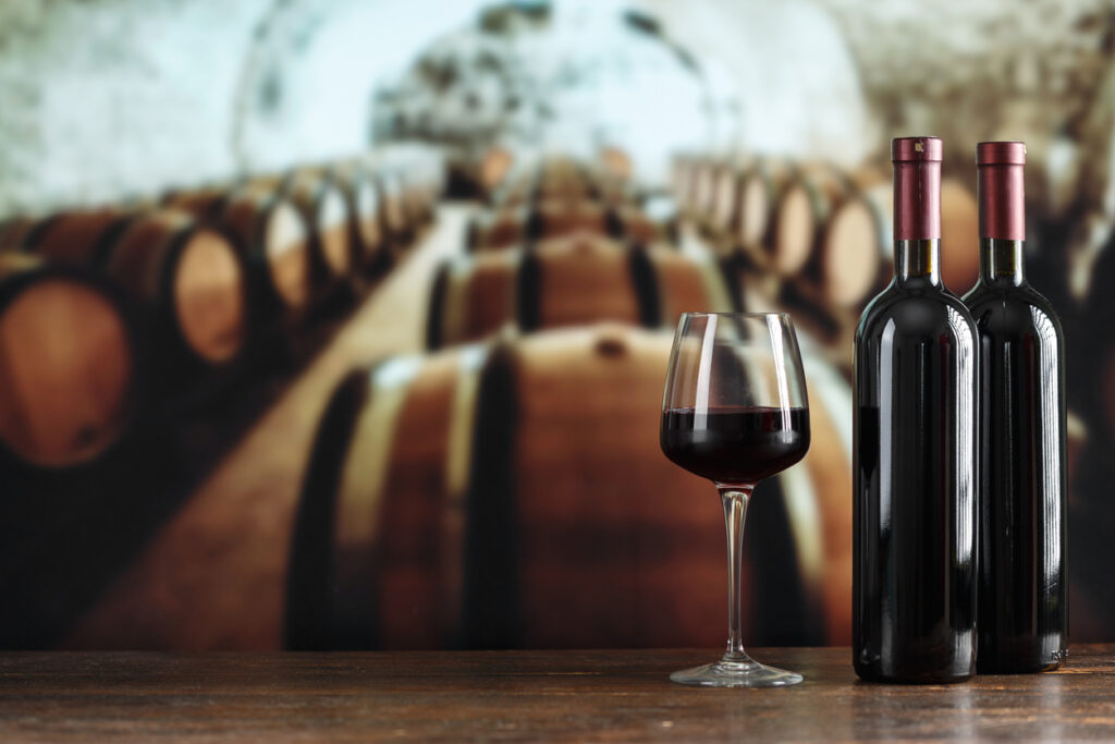 Wine cellar with a bottle of wine and glasses. Winemaking concept. Space for text.