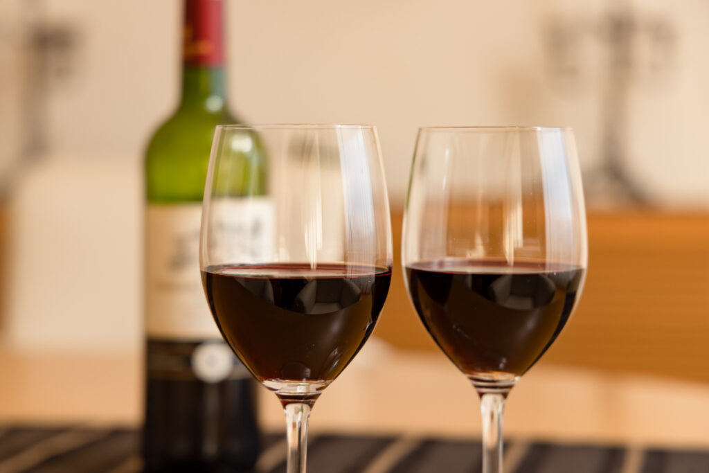 Delicious red wine and a glass to drink on an elegant holiday