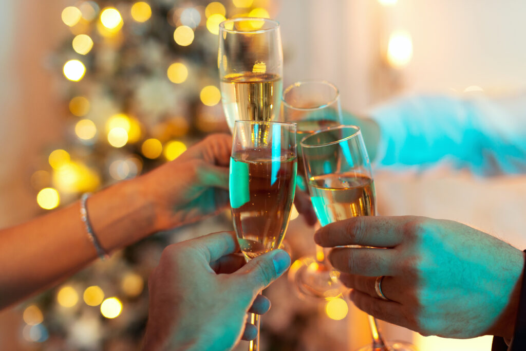 Close up shot of a group of people toasting glasses filled with champagne