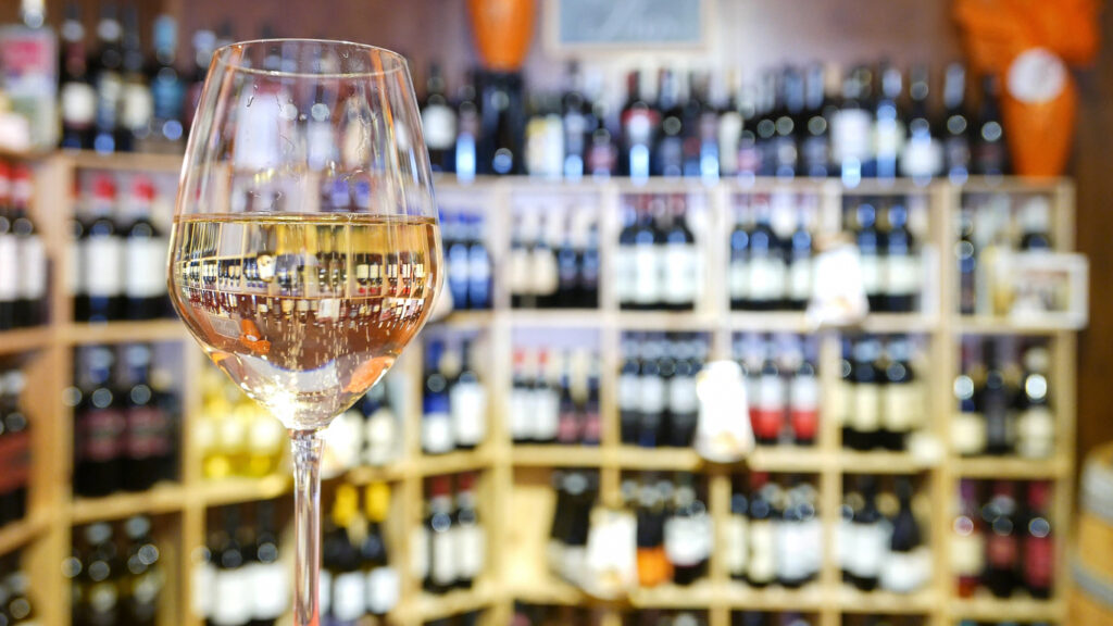 White wine glass in an Italian wine shop.