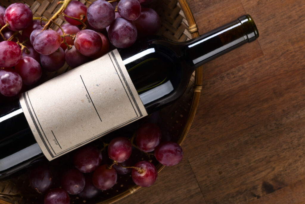 The bottle of red wine on old wooden table
